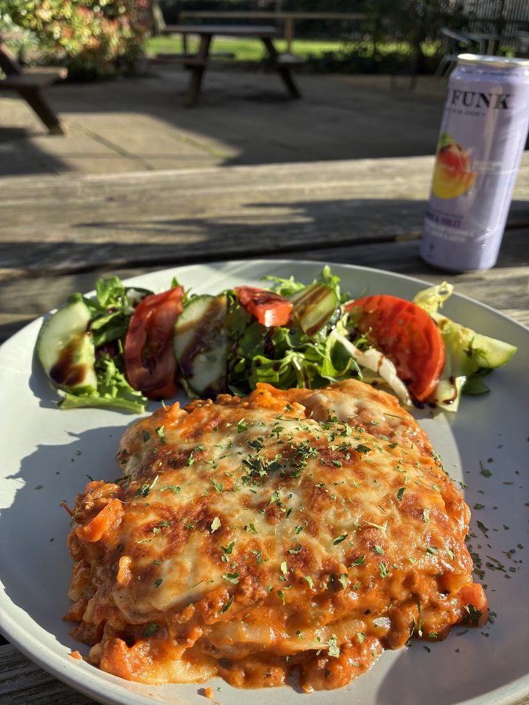 Pasta bake topped with melted cheese, served with salad